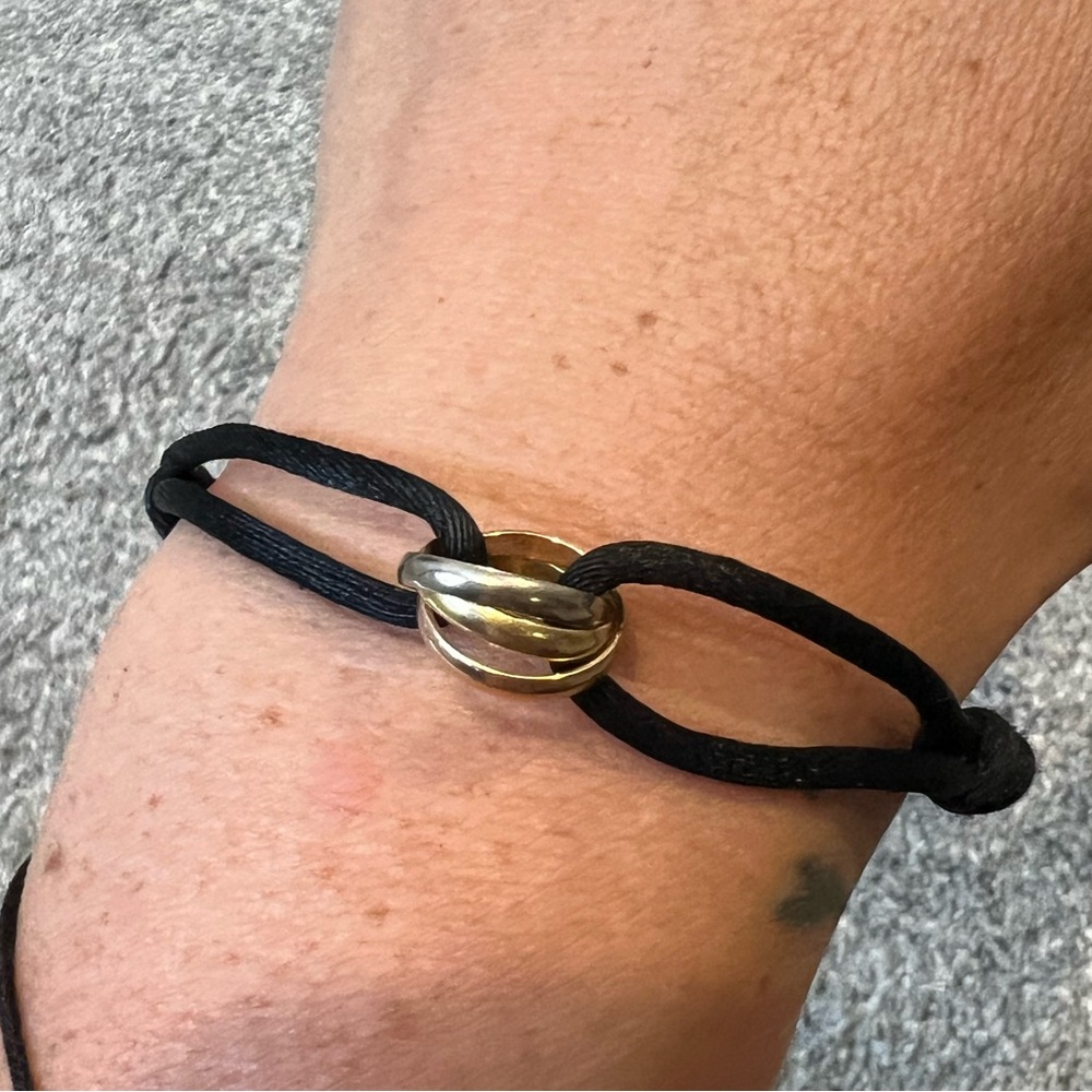 Cartier trinity bracelet with black cord